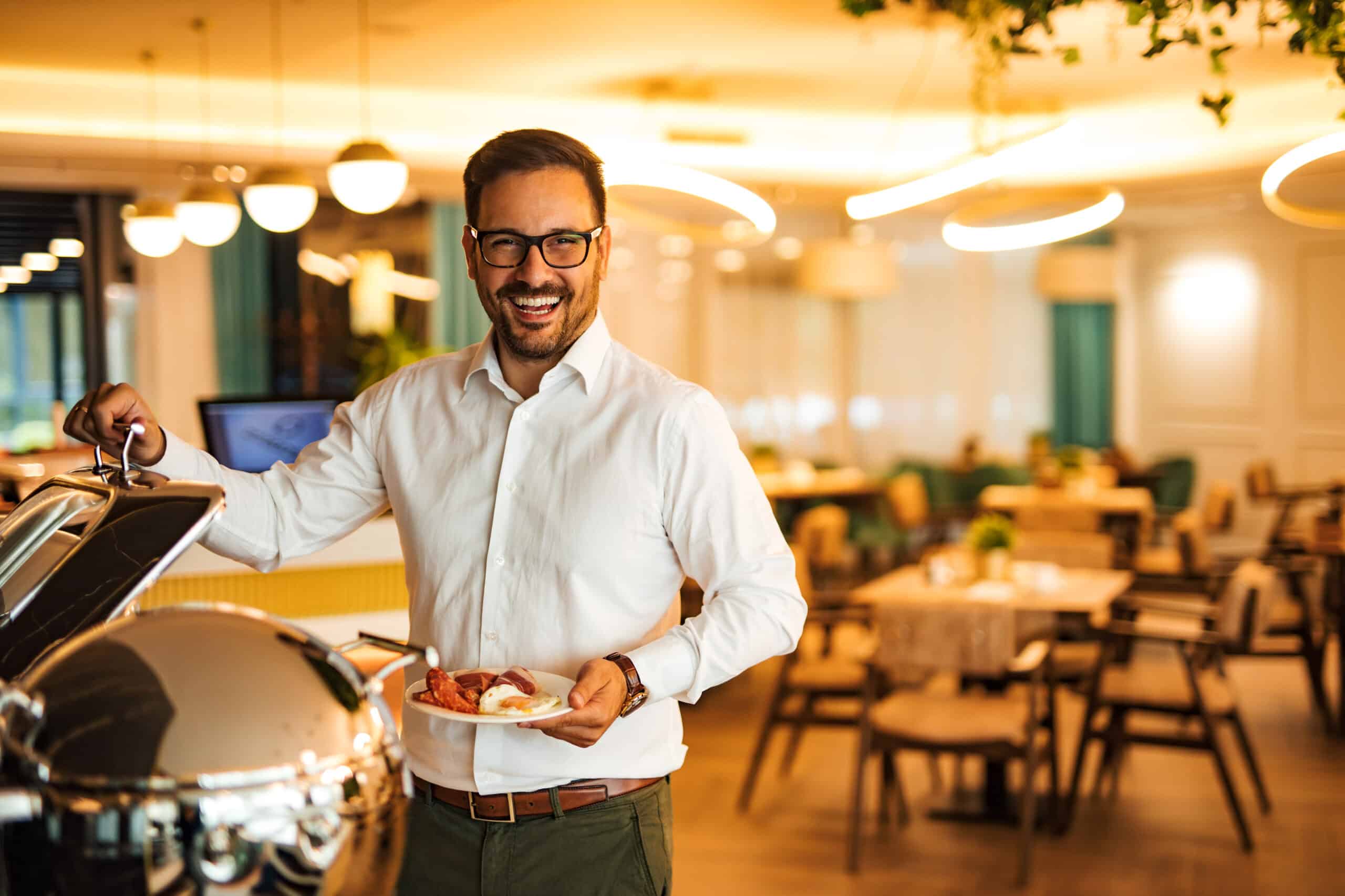 Portrait of a smiling elegant man at morning buffet.