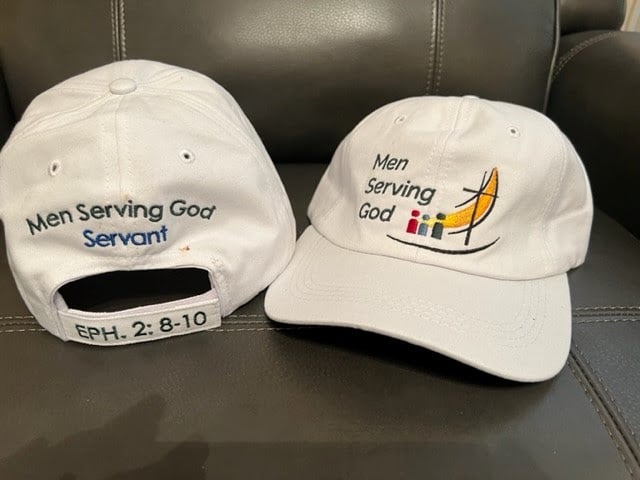Two white Men Serving God baseball caps featuring logo, the word “Servant,” and Ephesians 2:8–10 scripture reference