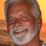 Smiling portrait of Dennis Brown at sunset honoring his legacy with Men Serving God