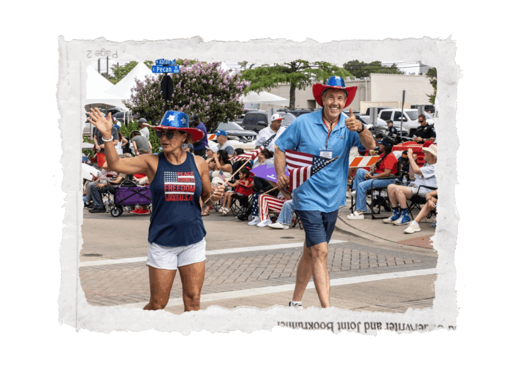 Jim Labenz smiling and waving American flag during Arlington parade while serving with Men Serving God
