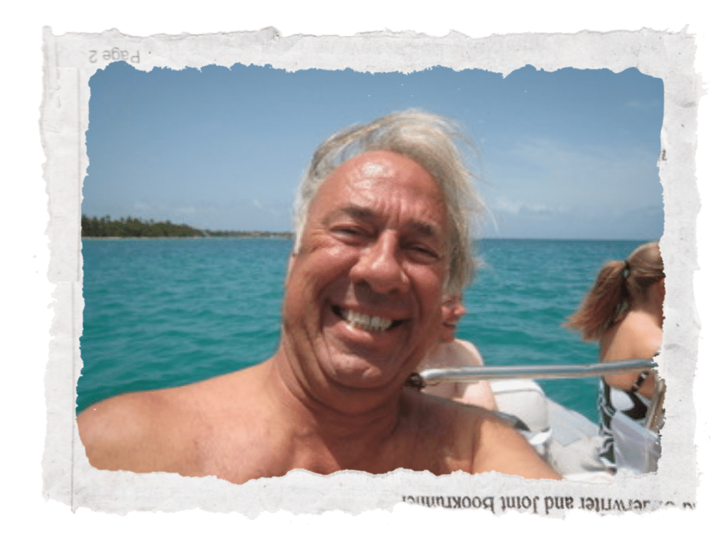 Michael Yaw smiling aboard his sailboat during missionary travels